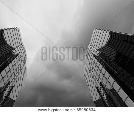 Bottom image of skyscraper with thunder lightning in sky