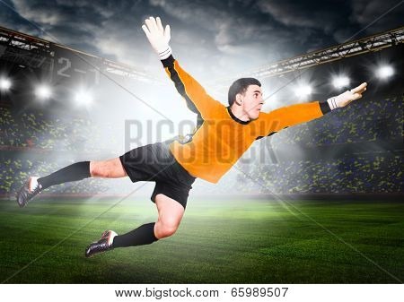 soccer or football goalkeeper is catching ball on stadium