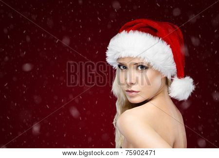 Pretty woman in Christmas cap, isolated on purple