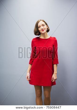 Woman In Hallway On Gray Wall Background