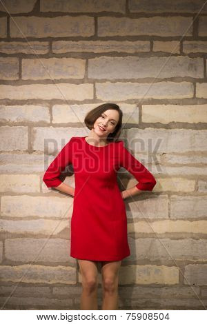 Woman In Hallway Holding Hands Behind Body