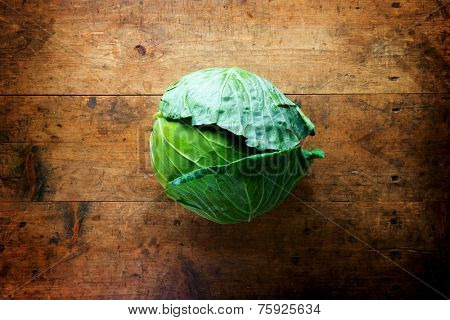 Fresh harvested cabbage, on a old grungy table. Vegetables with artistic impression 