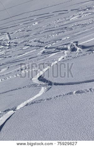 Traces Of Skis And Snowboards In New-fallen Snow