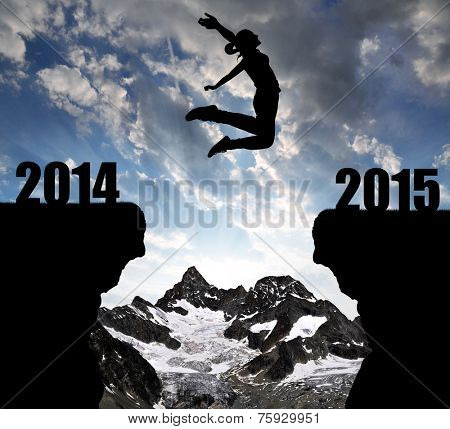 Girl jumps to the New Year 2015 in the background mount Ober Gabelhorn