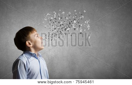 Cute boy of school age and letters flying around