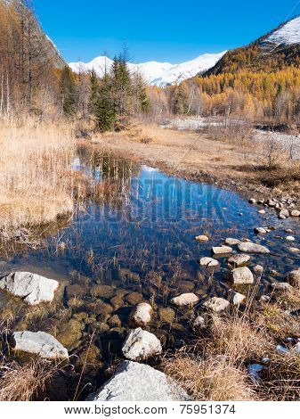 Small alpine mountain pond in fall - Val Ferret, Courmayer, Val d'Aosta, Italy, Europe.