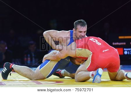 NOVOSIBIRSK, RUSSIA - NOVEMBER 8, 2014: Greco-Roman wrestling match Aslan Abdullin (blue singlet) vs Valery Gusarov during the Friendship Cup. The competitions include 10 kind of martial arts