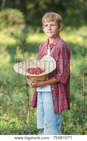 Portrait Of Standing Boy Holding Red Wildberries