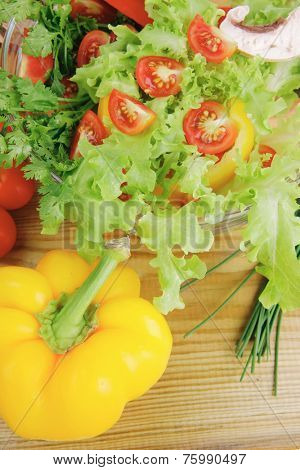fresh salad and cherry's on wooden table