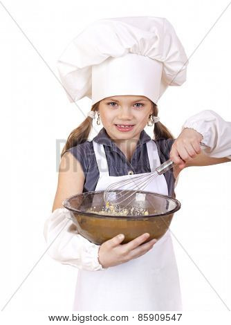 Little girl cook whips whisk eggs in a large plate, isolated on white background