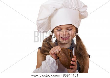 Cooking and people concept - smiling little girl in cook hat, isolated on white background