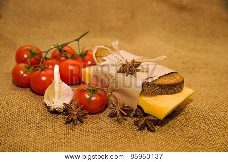 Sandwich With Cheese, Cherry Tomatoes And Garlic On Old Cloth