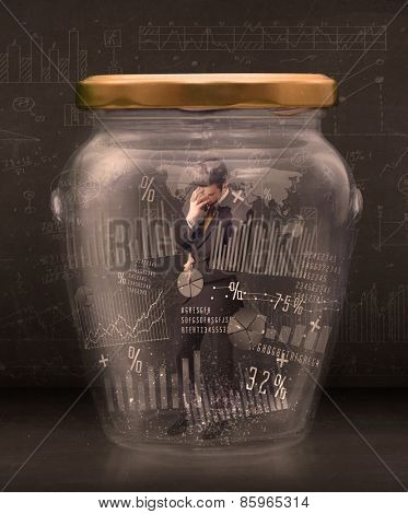 Businessman traped in jar with graph chart symbols concept on background
