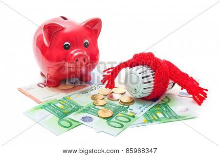 Heating thermostat with piggy bank and money, expensive heating costs concept