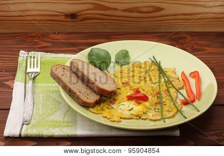 Egg Omelette With Paprika And Green Herbs And Bread