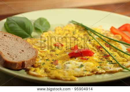 Egg Omelette With Paprika And Green Herbs And Bread