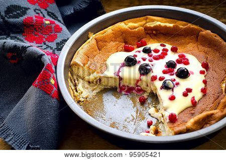 pudding with frozen berries and vanilla sauce