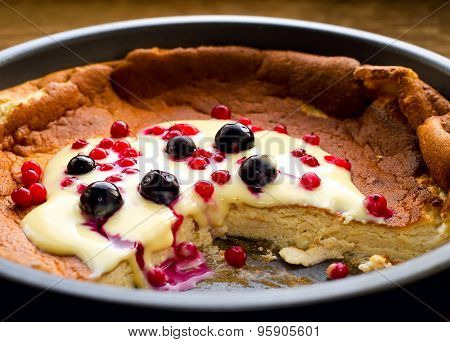 pudding with frozen berries and vanilla sauce