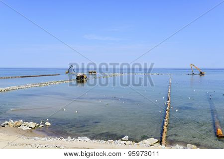 USTKA - JULY 04: Workers are building an artificial reef to facilitate the construction of the beach on 4 July 2015 in Ustka, Poland.