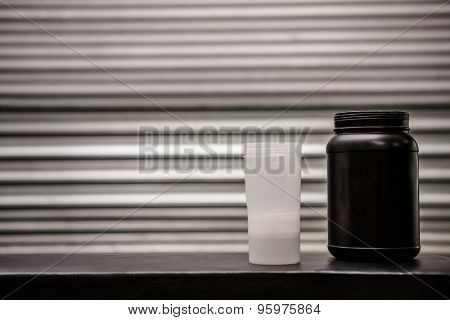 Protein powder drink and flask in crossfit gym