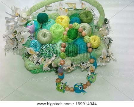 Basket. Greenish yarn. Colored balls of yarn. Valentine. All colors.