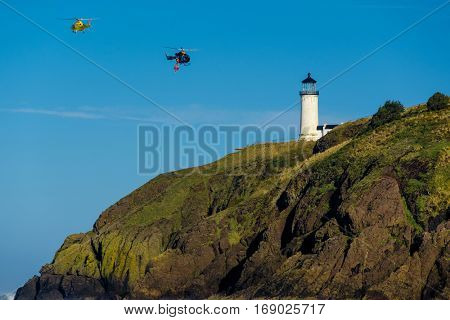 North Head Lighthouse at Pacific coast, Cape Disappointment, built in 1898, WA, USA. Coast guard helicopters in the sky.