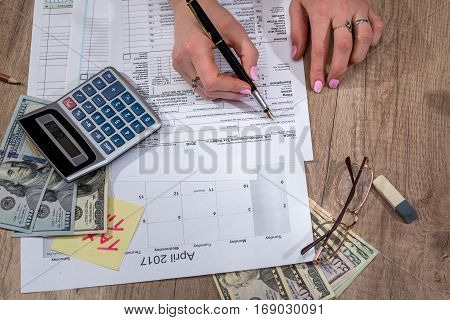 Business lady filling tax form. 2017. Financial concept.