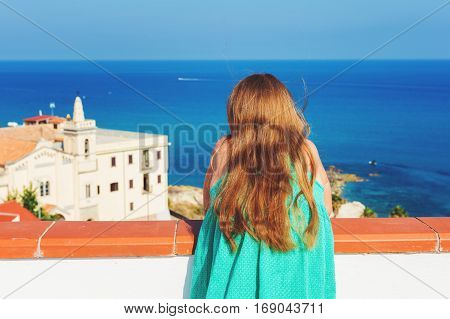 Little kid girl admoring beautiful sea view, image taken in Tropea, Calabria, South of Italy