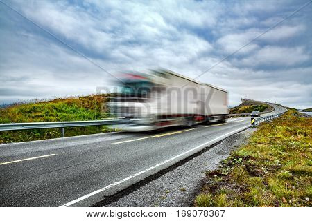 Truck and highway at sunset. Truck Car in motion blur. Atlantic Ocean Road or the Atlantic Road (Atlanterhavsveien) been awarded the title as 