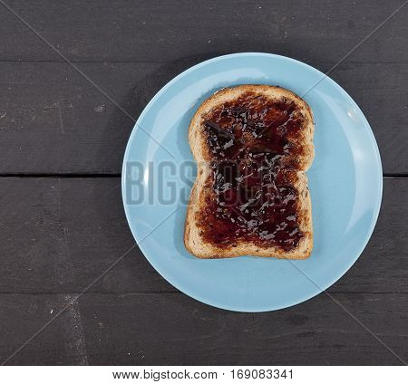 Typical Dutch apple syrup called Appelstroop on bread on wooden background