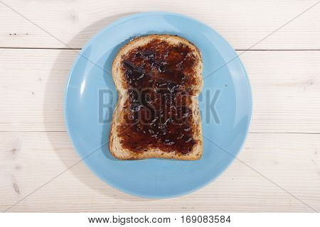 Typical Dutch apple syrup called Appelstroop on bread on wooden background