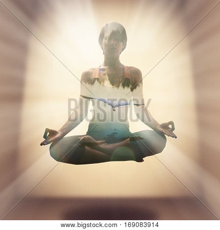 Yoga concept. The image is created using the multiple exposures. Image of a silhouette of a young woman soaring in the lotus position in the rays and flying bird above the water surface