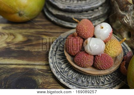 Tropical fruit - Lychees on wooden background