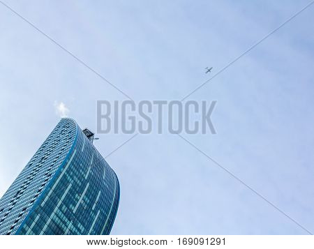 TORONTO, ONTARIO - DECEMBER 21, 2016: plane flying over a skyscraper in downtown Toronto, Ontario, Canada