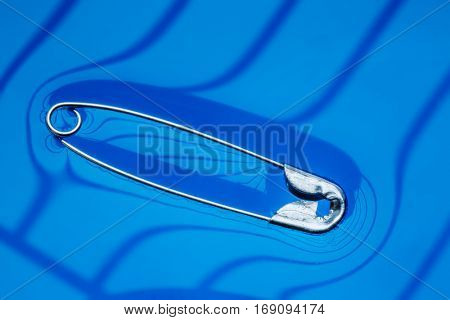 Physical experiment - pin floating on water surface.