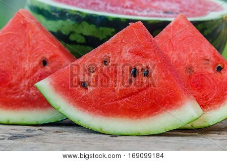 water melon slice on wood texture in nature background.