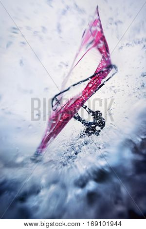 windsurfing in extreme conditions, surfing in waves with a lot of spray and speed
