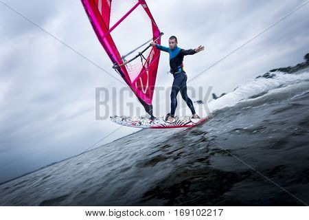 freestyle windsurfer doing tricks looking at the camera