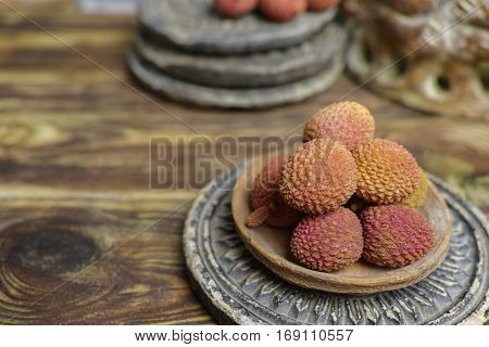 Tropical fruit - Lychees on wooden background