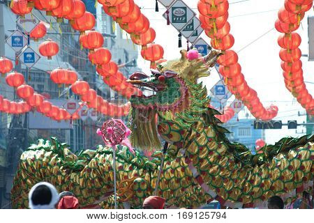 NAKHONSAWAN , THAILAND - JANUARY 31,2017 : Group Parade of Golden dragon show at Middle market in Nakhonsawan city during the Chinese New Year celebrations in Nakhonsawan Province ,Middle of Thailand.