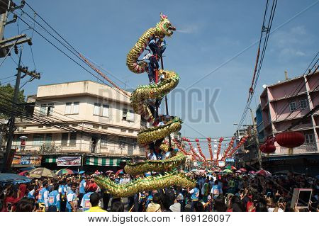 NAKHONSAWAN , THAILAND - JANUARY 31,2017 : Group Parade of Golden dragon show at Middle market in Nakhonsawan city during the Chinese New Year celebrations in Nakhonsawan Province ,Middle of Thailand.