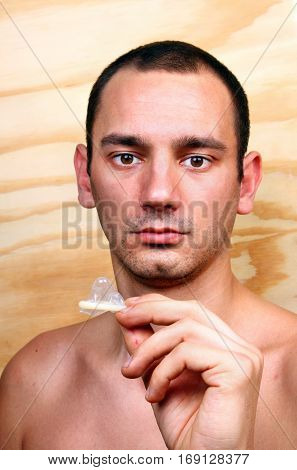 Young Handsome Boy And Condom