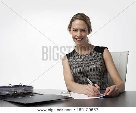 Business woman in office with pen and adminstration