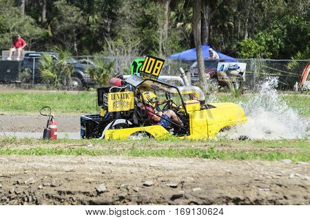 Naples Florida USA - March 3 2012: Swamp buggy powering through mudhole