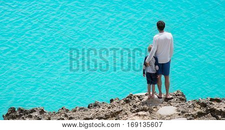 panorama of father and son enjoying beautiful anguilla island at caribbean