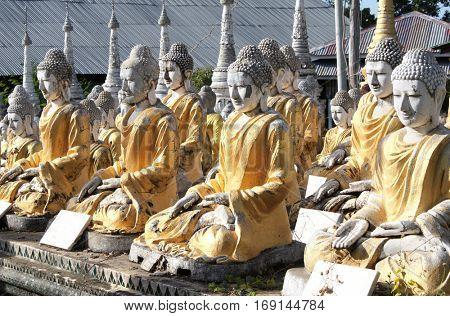 Rows of old stone statues of Buddha, Aung Setkya Paya, near to famous Bodhi Tataung temple complex, Monywa, Sagaing Region, Myanmar (Burma)