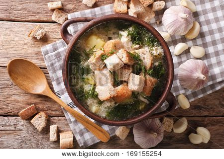 Delicious Garlic Soup With Croutons In A Bowl Close-up. Horizontal Top View