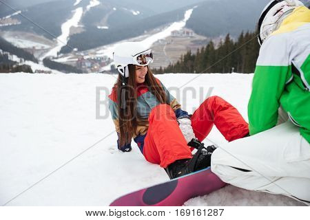 Photo of cheerful loving couple snowboarders on the slopes frosty winter day. Look aside.