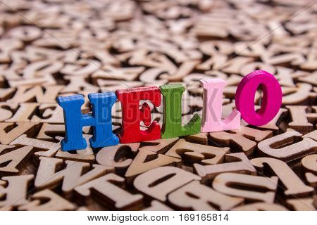 Hello word made from colored wooden letters on an old table. Concept
