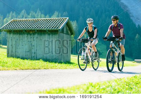 Cycling senior couple enjoying summer at the vilsalpsee in austria